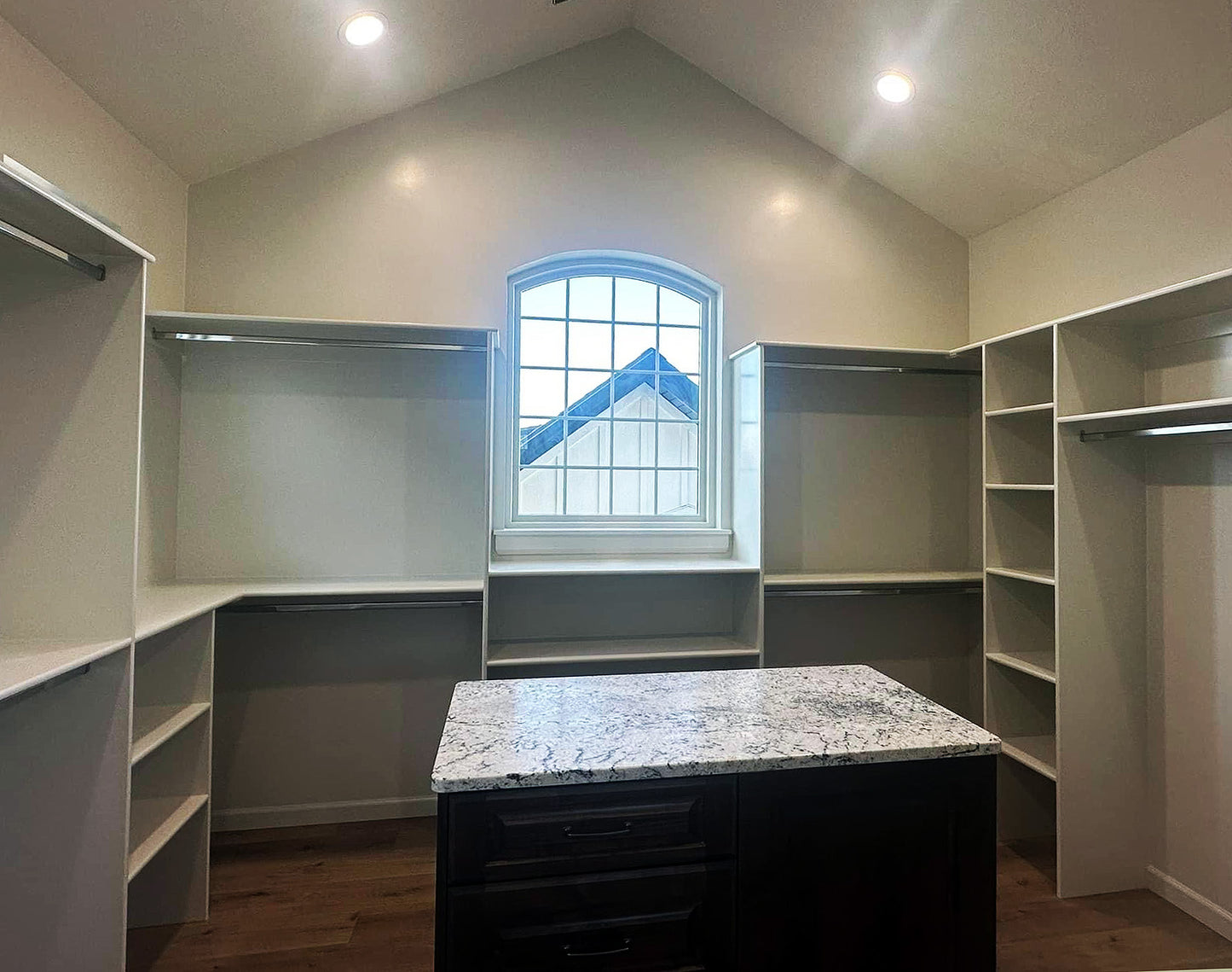 a large walk in closet with a marble counter top