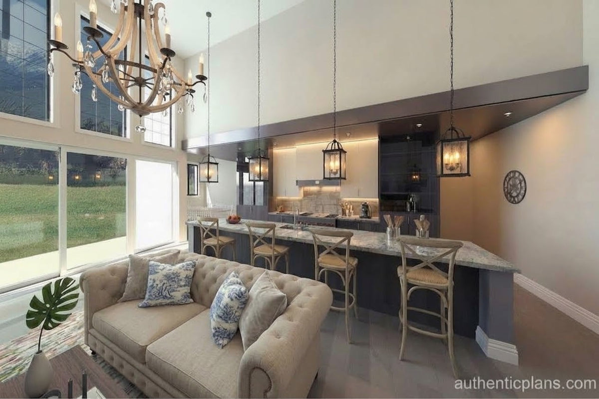 A modern open-plan living and kitchen interior featuring a tufted beige sofa in the foreground, a kitchen island with bar stools, pendant lights, and a large chandelier, with tall windows looking out onto a grassy lawn.