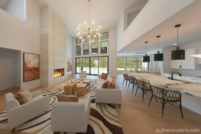 Modern living room with white furniture, fireplace, and kitchen in the background. Design by Authentic Homes in Utah.