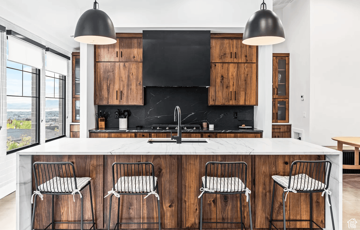Modern kitchen in Provo, Utah. House plan by Authentic Homes Custom Home Builder design/build in Utah. Soapstone, black hood.