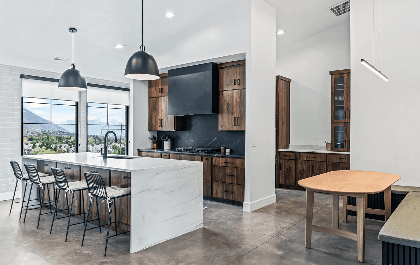 Modern No.10 house plan kitchen with marble island, wood cabinetry, and built-in breakfast nook by Authentic Homes builder in Utah. Bult in Provo, Utah by Authentic Homes.