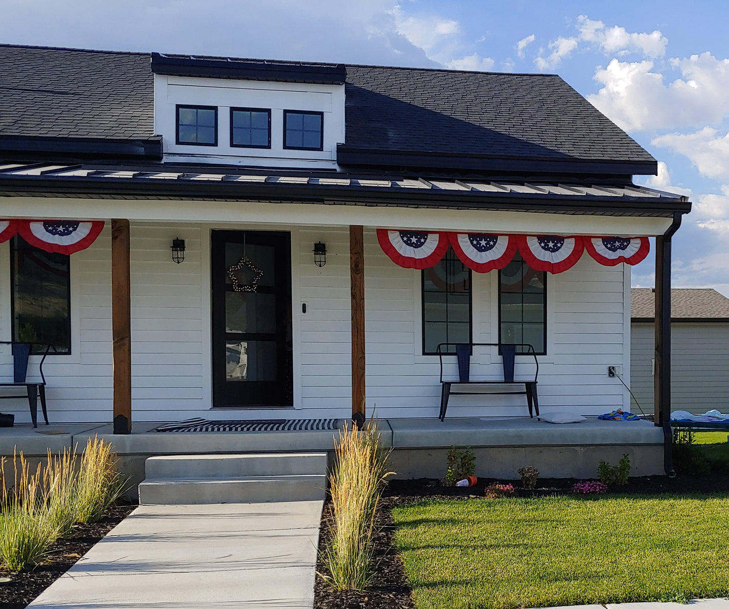 House plan exterior, design by Authentic Homes in Utah. Farmhouse styling with white stucco, siding. Built in Payson, dormer, large porch.