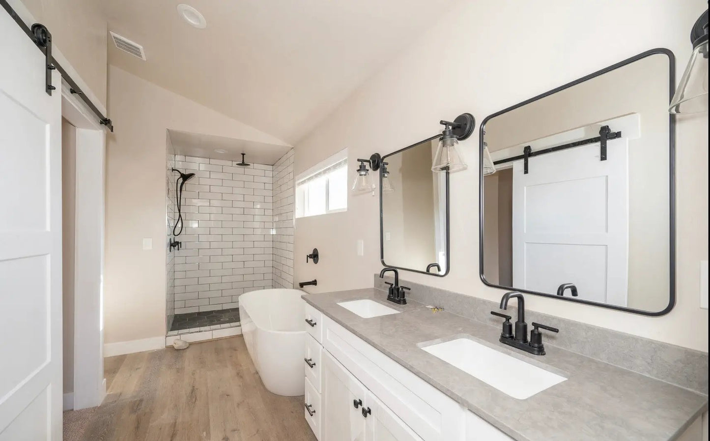a bathroom with two sinks, a tub and a shower